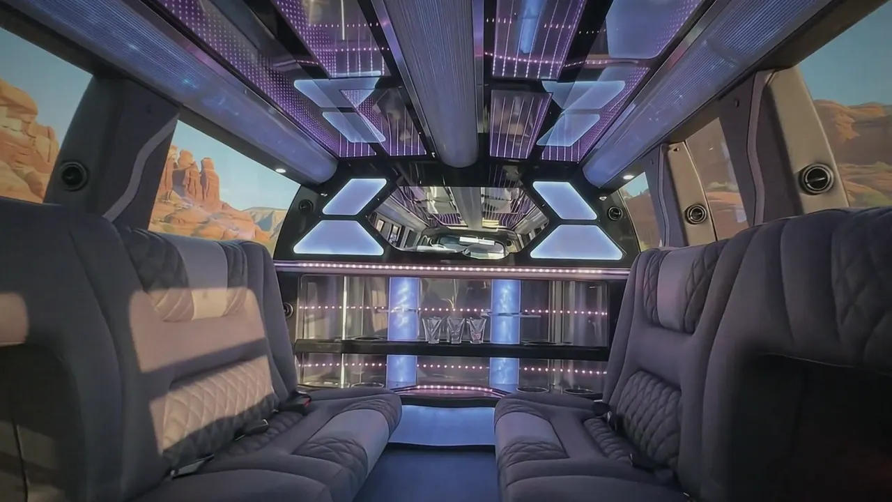 Inside the Cadillac Escalade limo in Castle Rock: LED light-show ceiling, leather lounge seating and lit bar